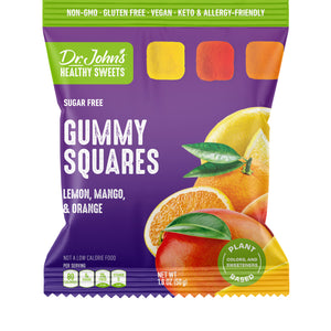 A bag of Dr. John's Healthy Sweets Gummy Squares, lemon, mango, and orange flavor, in a purple and green package with fruit illustrations.